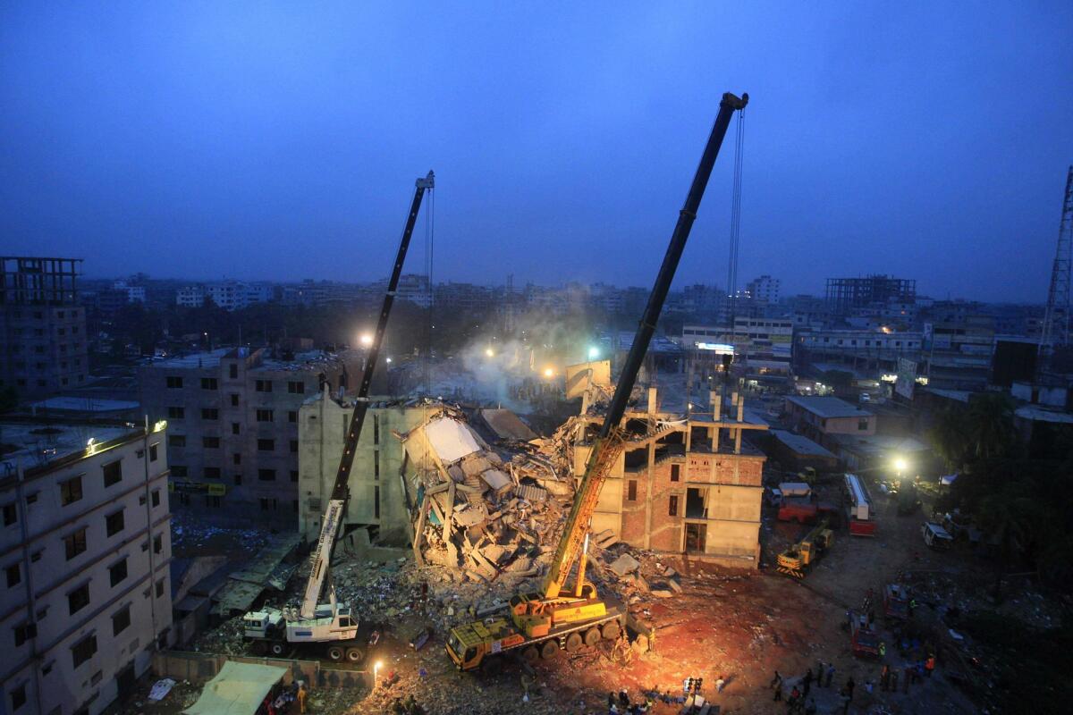 Cranes operated by Bangladeshi army personnel are at the scene days after the April 24, 2013, collapse of an eight-story building in Dhaka. Bangladeshi police on Monday charged the owner of the Rana Plaza factory complex and others with murder in the collapse that killed 1,137 people.