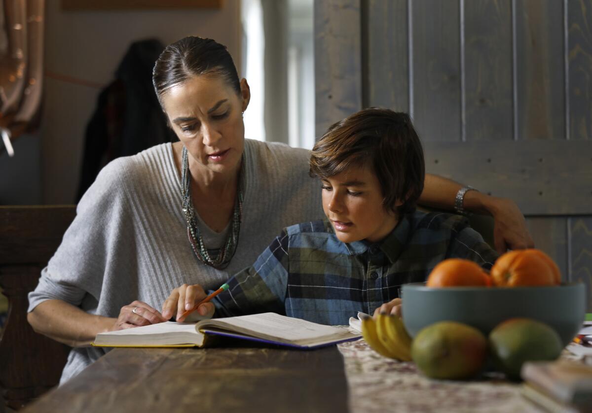 Karen Mozian home schools her sixth-grade son, Elijah, 11, at their home in Redondo Beach.