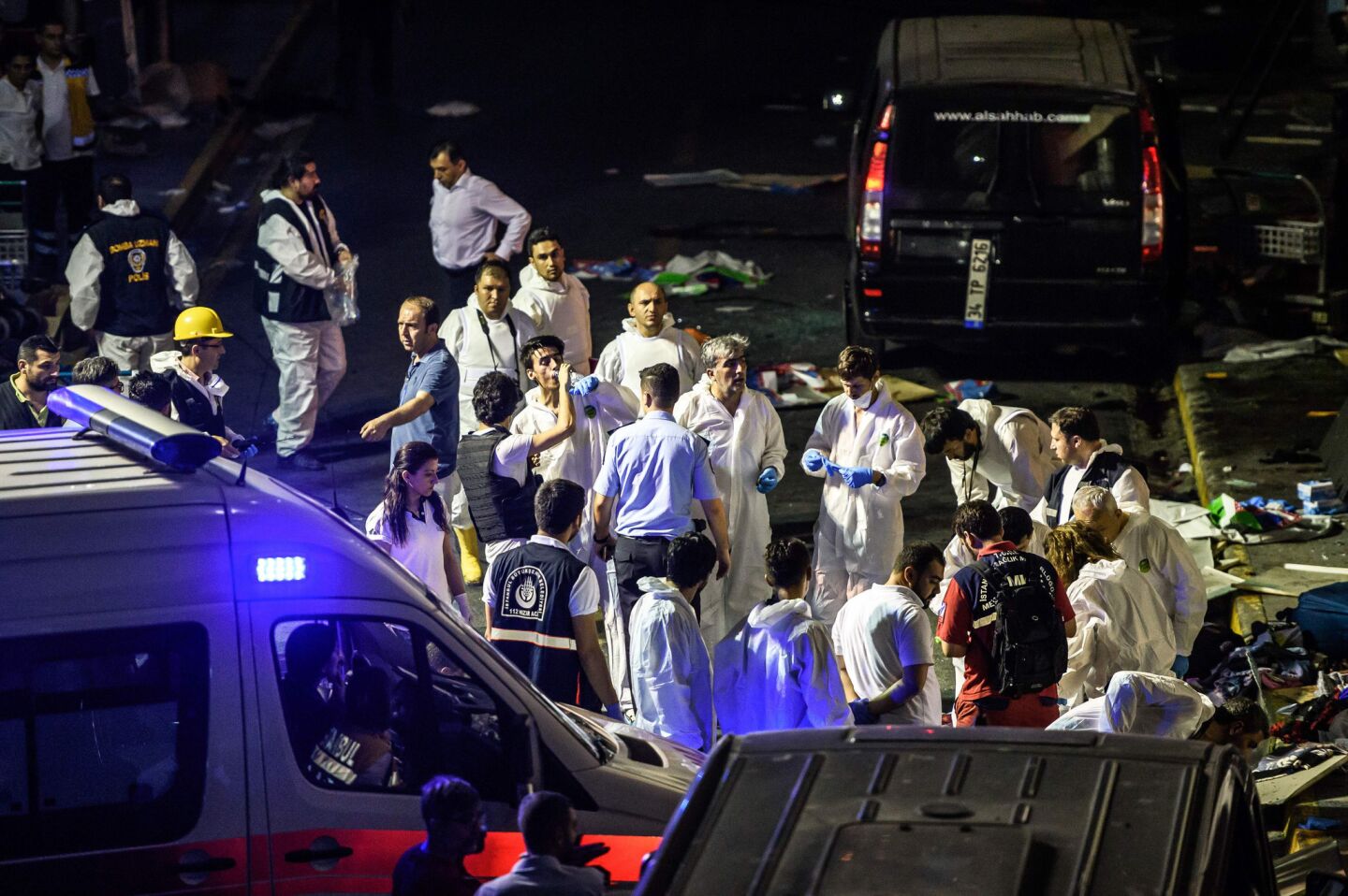 Forensic police work the explosion site at Ataturk airport.