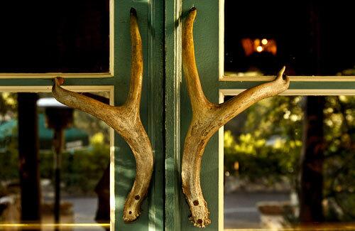 Antler door handles greet customers at the entrance of Saddle Peak Lodge in Calabasas.