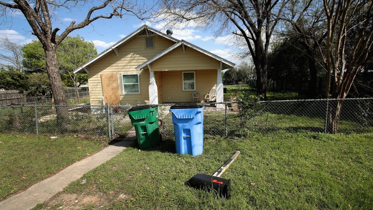 Plywood covers most of the windows at the home of Mark Anthony Conditt after the police investigated the property on Thursday in Pflugerville, Texas.
