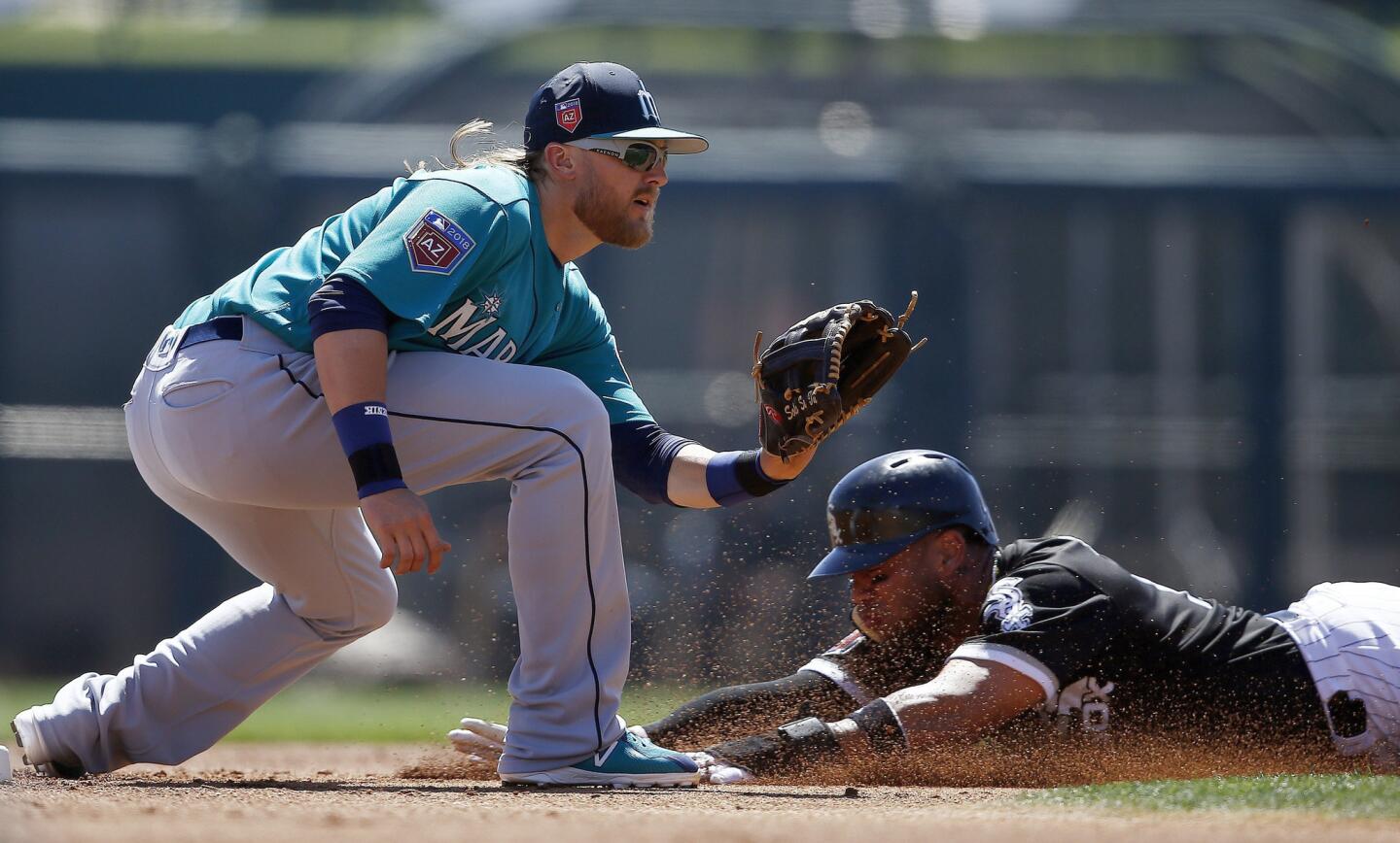 Yoan Moncada slides safely into second base with a steal as the Mariners' Taylor Motter waits for a late throw during the first inning of a spring game on March 23, 2018, in Glendale, Ariz.