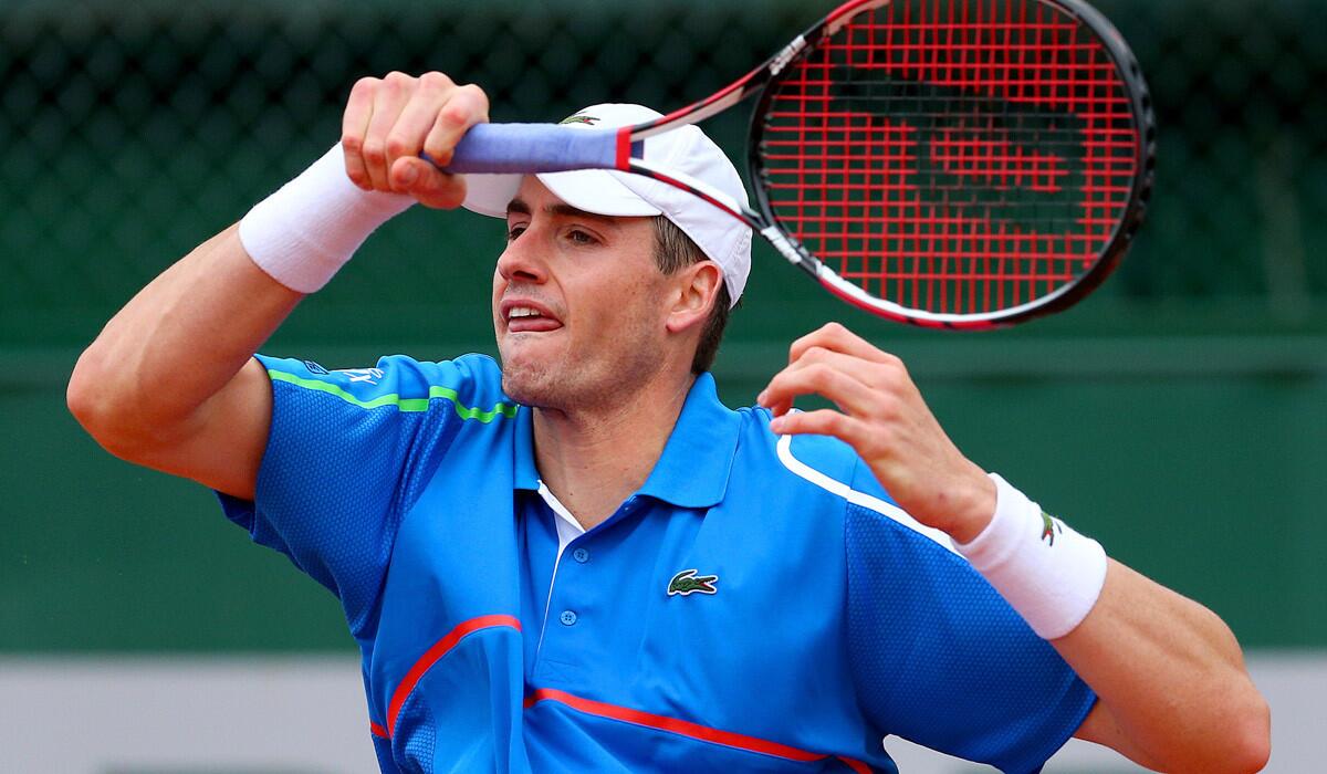 John Isner returns a shot during a second-round victory over Mikhail Kukushkin at the French Open.