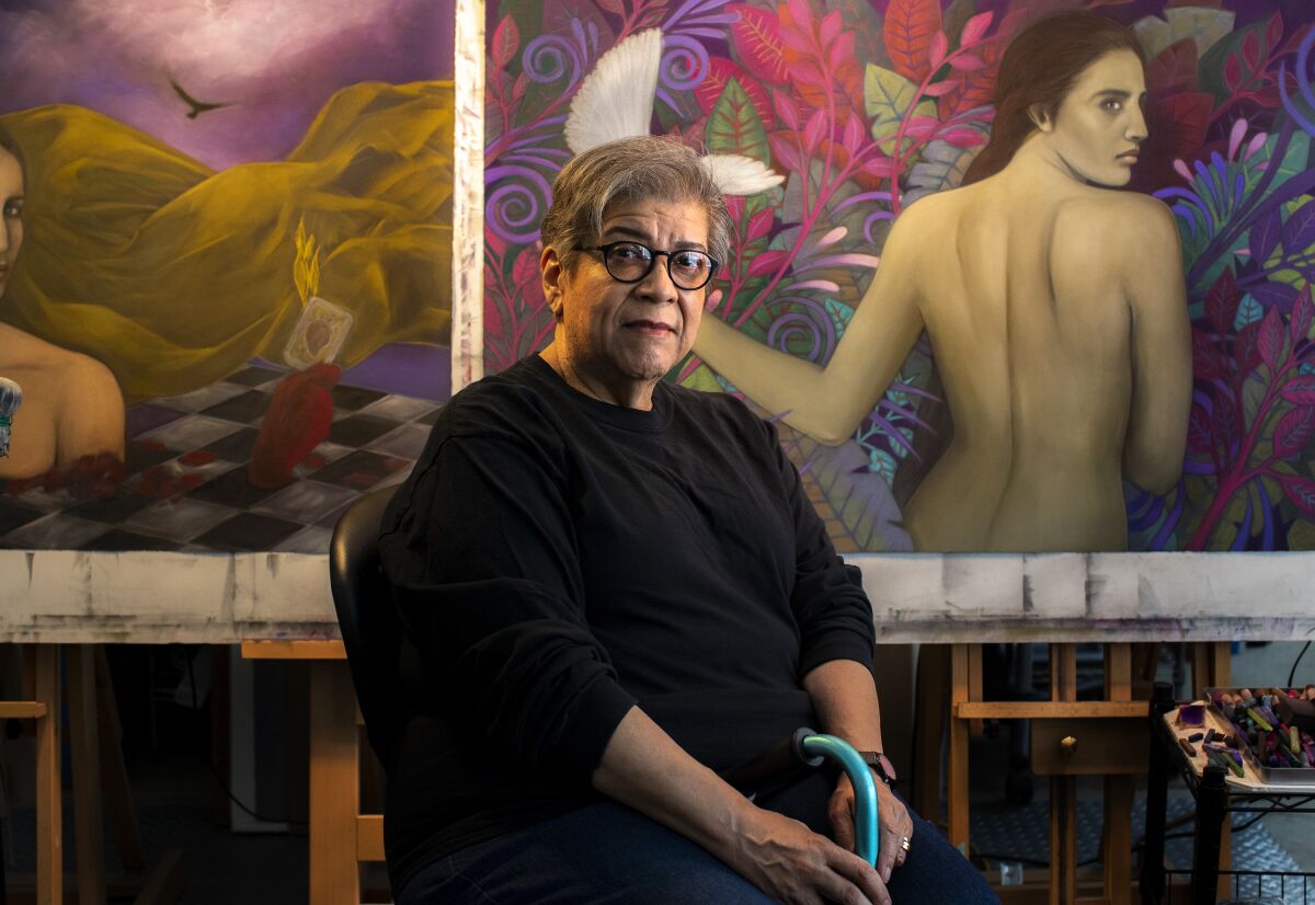 Painter and muralist Judithe Hernandez  sits in front of pastel works of art at her Highland Park studio on Aug. 15, 2020.