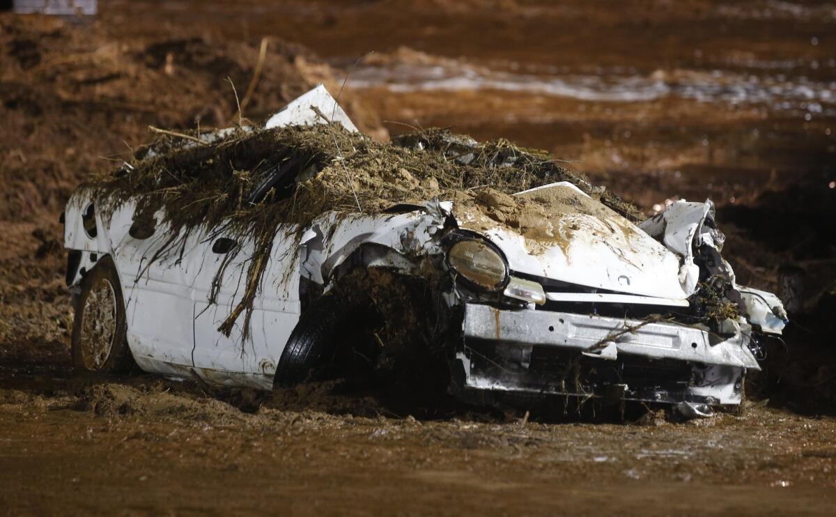 A car sits on the side of the road after being pulled from Short Creek in Hildale, Utah, after flash floods washed away two cars.