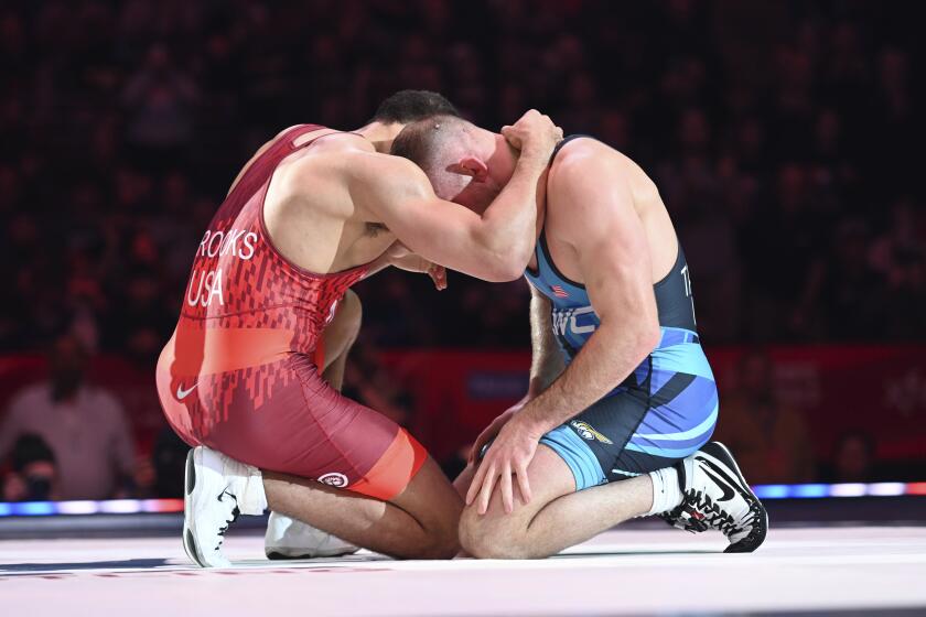 Aaron Brooks, left, and David Taylor embrace after a bout at 86 kilograms in the finals at the U.S. Olympic wrestling team trials in State College, Pa., Saturday, April 20, 2024. (AP Photo/Aidan Conrad)