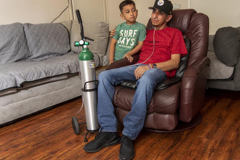 PACOIMA, CA-SEPTEMBER 8, 2023: Leobardo Segura Meza, 27, who suffers from silicosis, an incurable lung disease that has been afflicting workers who cut and polish engineered stone high in silica, is photographed with his son Leo Gael Segura, 4, at his home in Pacoima. (Mel Melcon / Los Angeles Times)