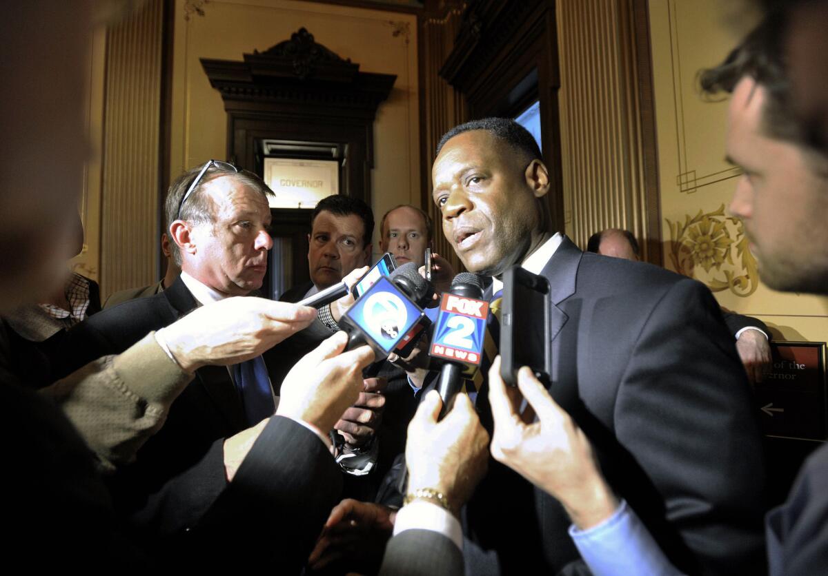 Detroit Emergency Manager Kevyn Orr, center, discusses the Detroit bankruptcy outside the governor's office at the Michigan Capitol in Lansing last month. Retiree groups face tough decisions on their pension claims as Detroit attempts to exit from bankruptcy by October.