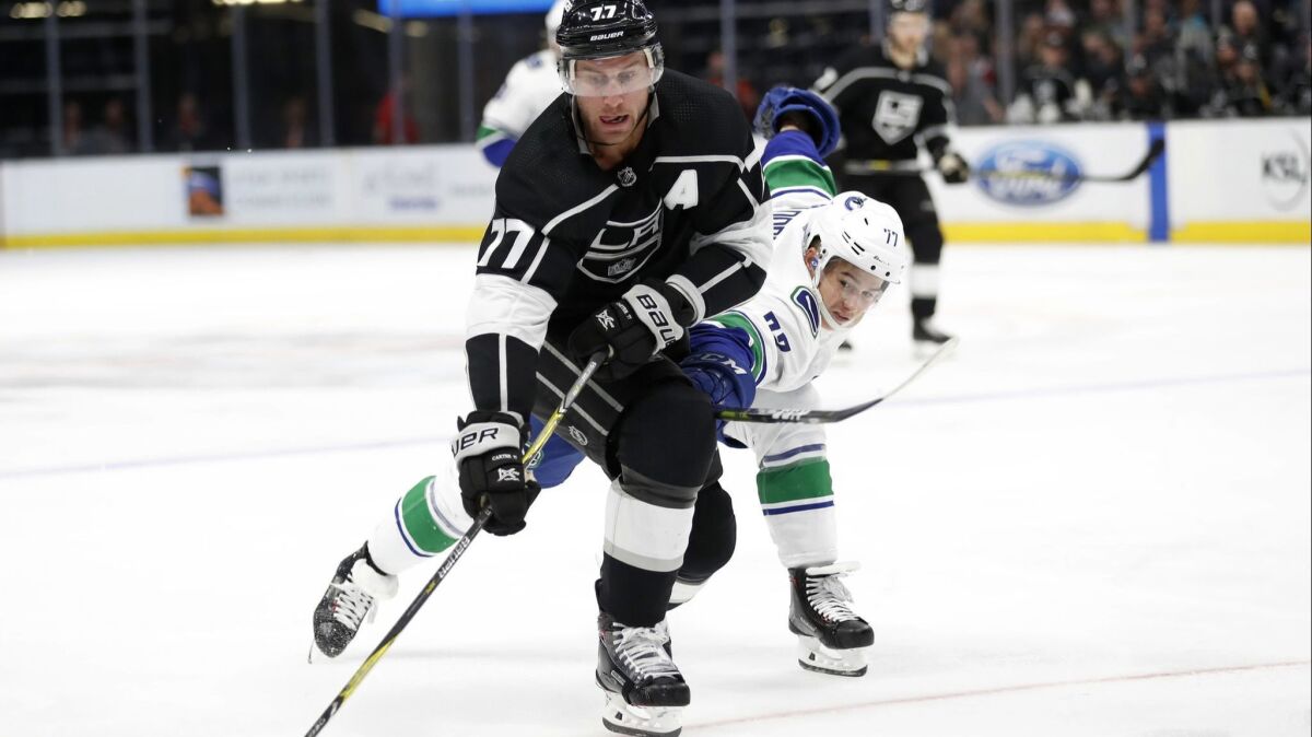 Kings forward Jeff Carter (77) and Vancouver Canucks forward Nikolay Goldobin (77) battle for the puck in the third period of a preseason game on Sept. 24 in Salt Lake City.