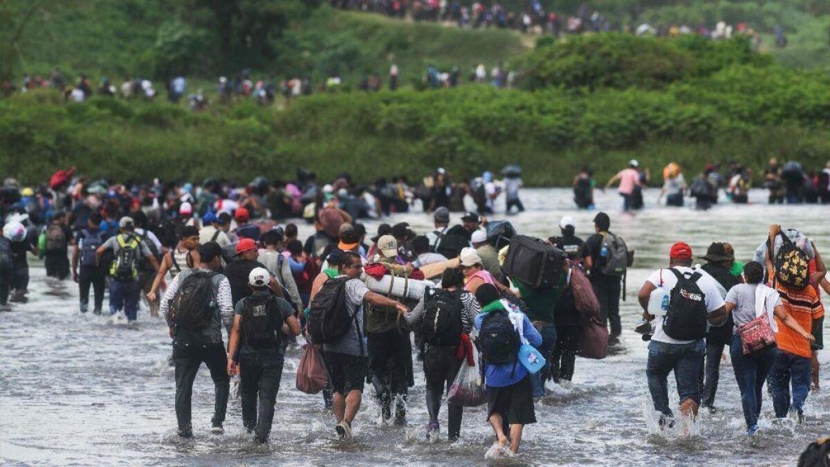 A large group of Salvadoran migrants attempting to reach the United States crosses the Suchiate River into Mexico on Nov. 2.