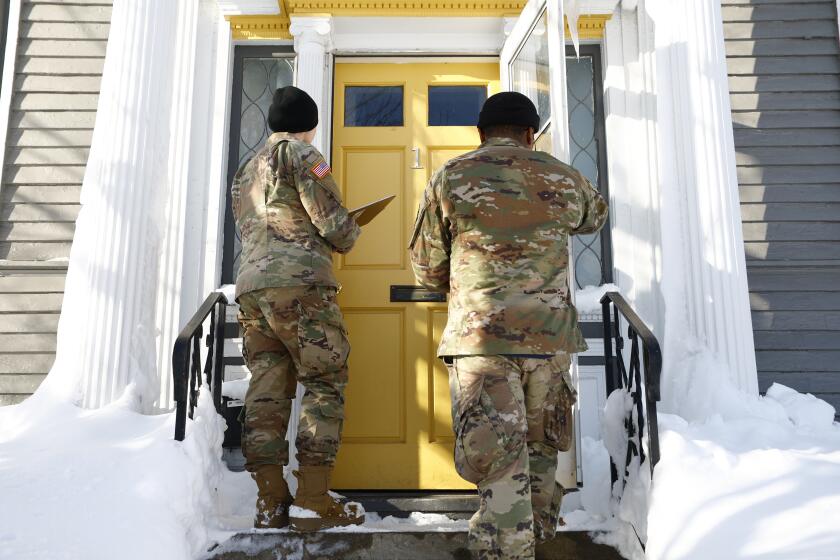 National guard members check on residents, Wednesday, Dec. 28, 2022, in Buffalo N.Y., following a winter storm. (AP Photo/Jeffrey T. Barnes)