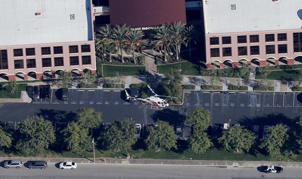 SAN BERNARDINO, CALIF. DEC.2, 2015 - A police heicopter hovers around the Inland Regional Center in San Bernardino, scene of a mass shooting on Wednesday, Dec. 2, 2015. Fourteen people have been reportedly killed in the shooting and three suspects are still at large. (Luis Sinco/Los Angeles Times)