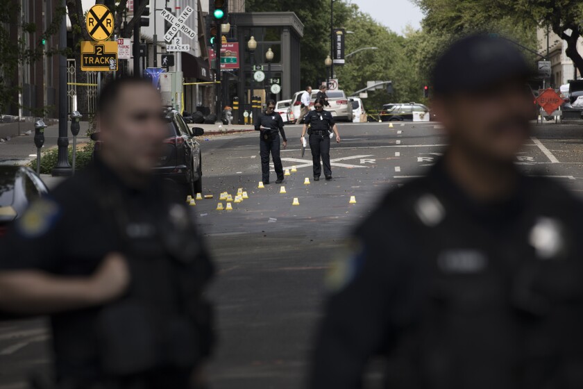SACRAMENTO, CALIFORNIA - APRIL 03: Police officers work at the scene of a mass shooting on April 3, 2022 in Sacramento, California. Six adults were killed and 12 other people were injured in a mass shooting occurred early morning on Sunday in Sacramento, Xinhua News Agency reported. (Photo by Liu Guanguan/China News Service via Getty Images)