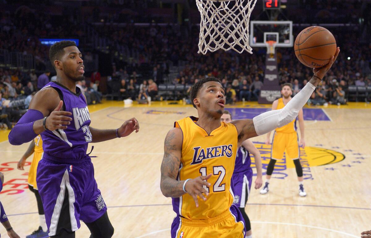 Lakers guard Vander Blue goes up for a left-handed shot to avoid the defensive presence of Kings forward Jason Thompson.