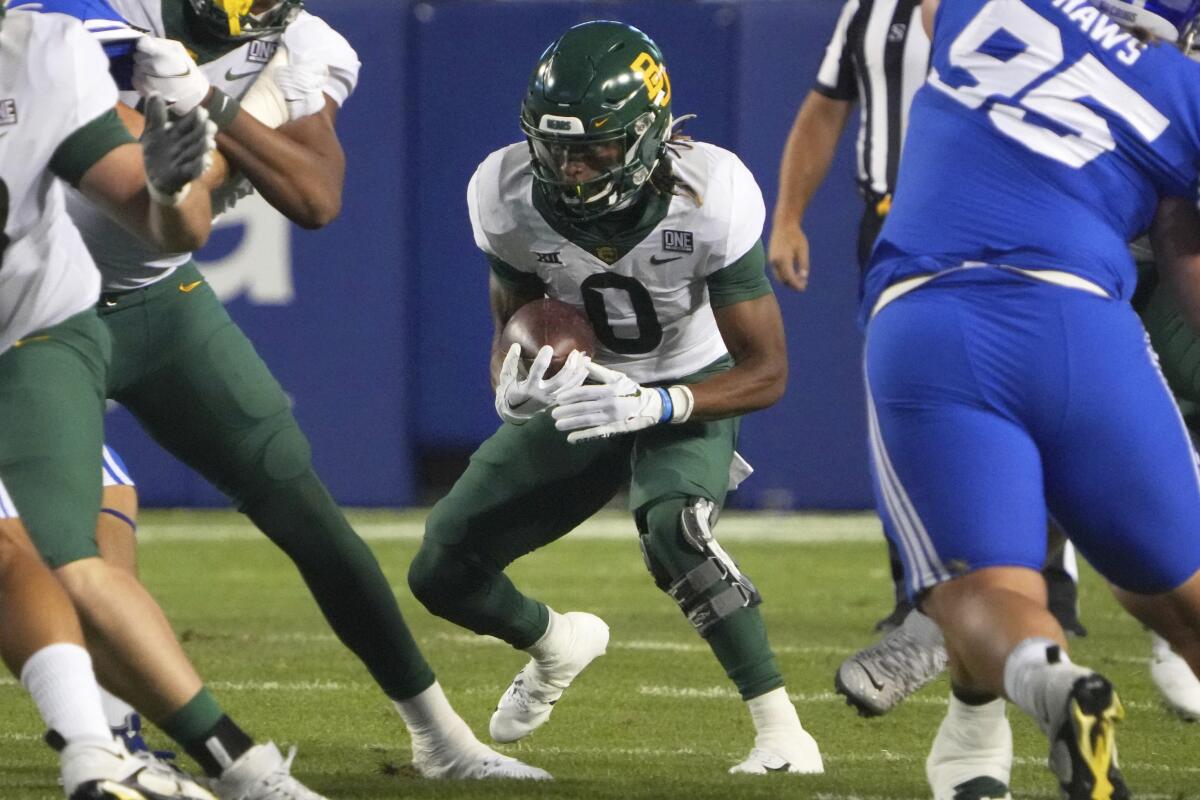 Baylor running back Craig Williams (0) looks for an opening in the first half of an NCAA college football game against BYU, Saturday, Sept. 10, 2022, in Provo, Utah. (AP Photo/George Frey)
