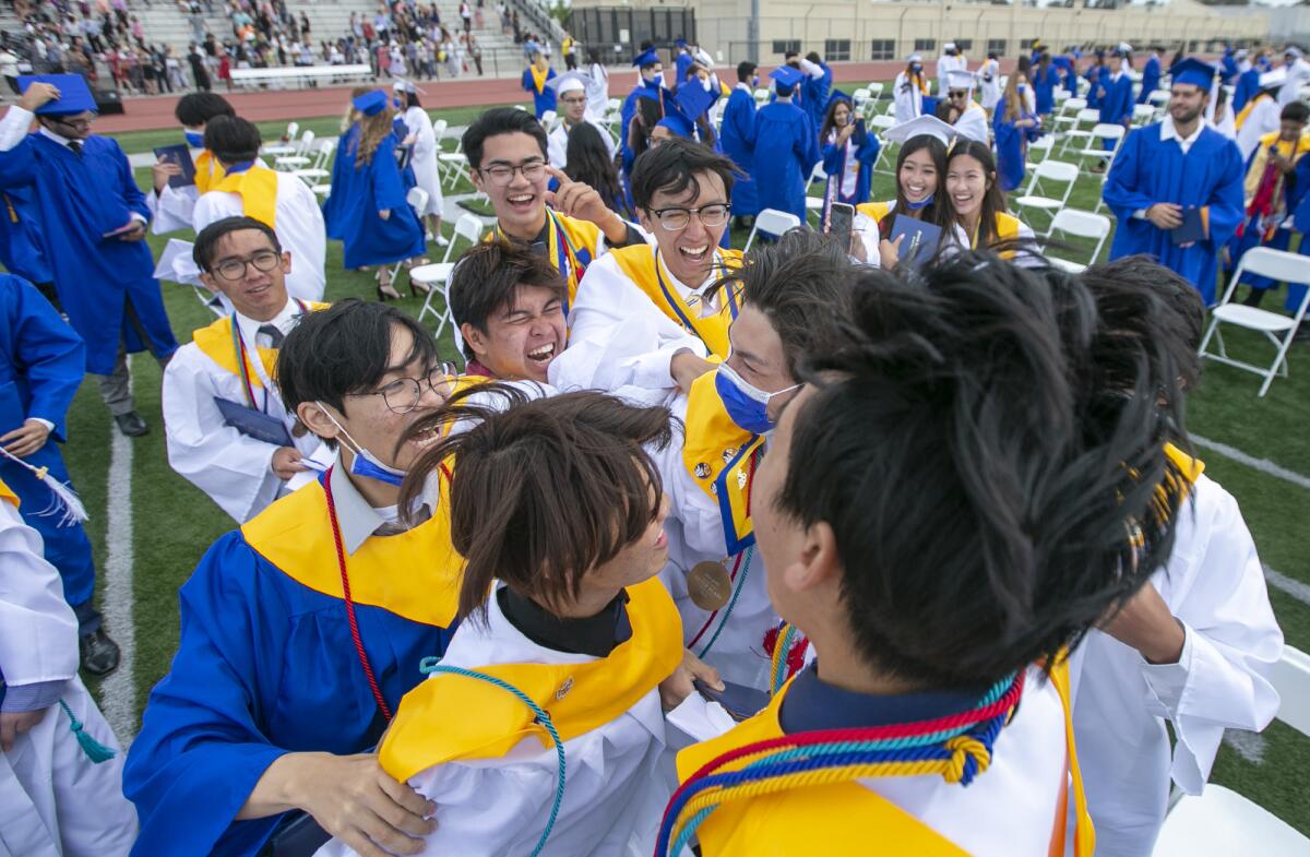 A group of graduates celebrates during the 2021 Fountain Valley High School commencement at Huntington Beach High School.