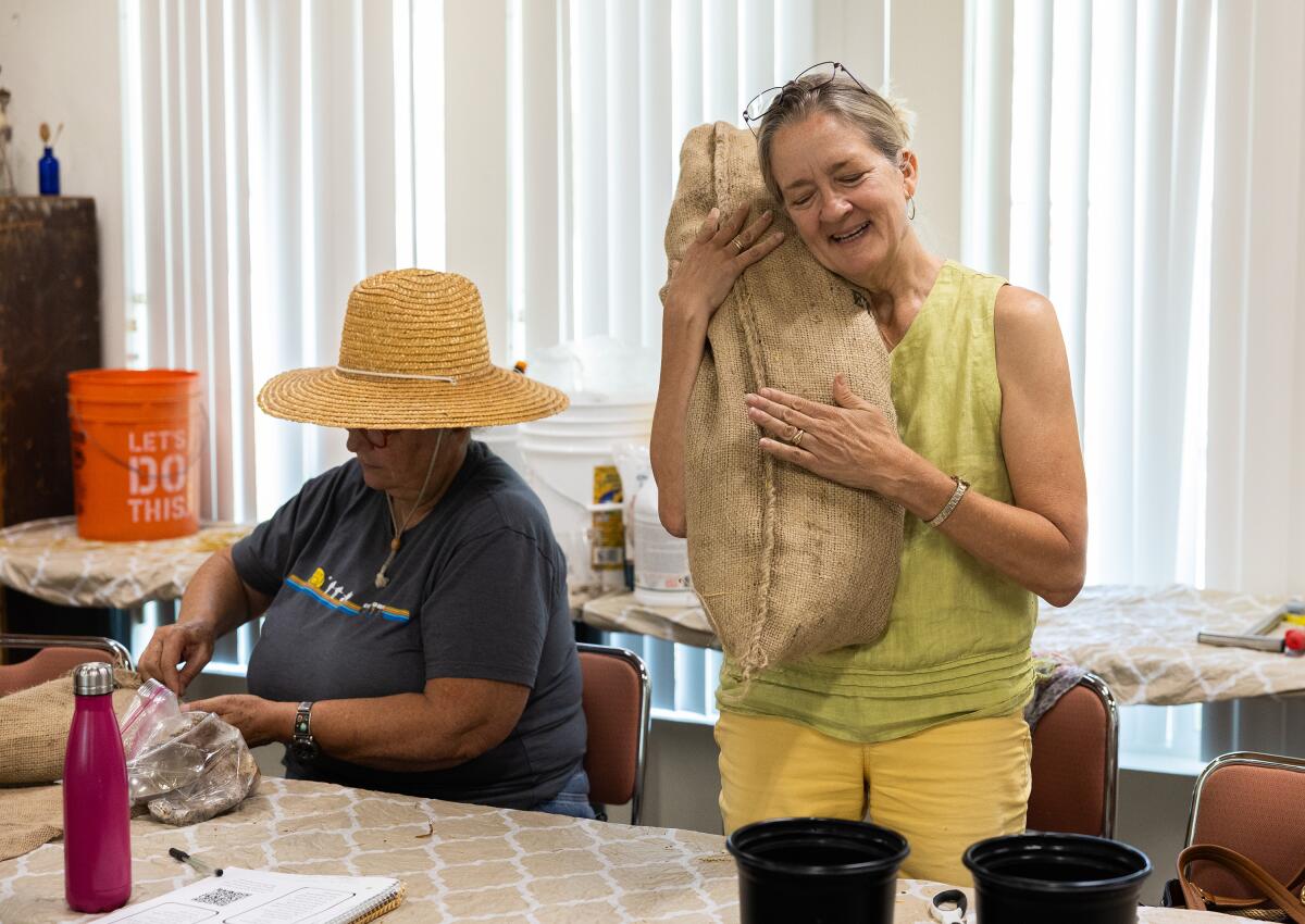 Leslie Carothers with her oyster mushroom filter sock that she made