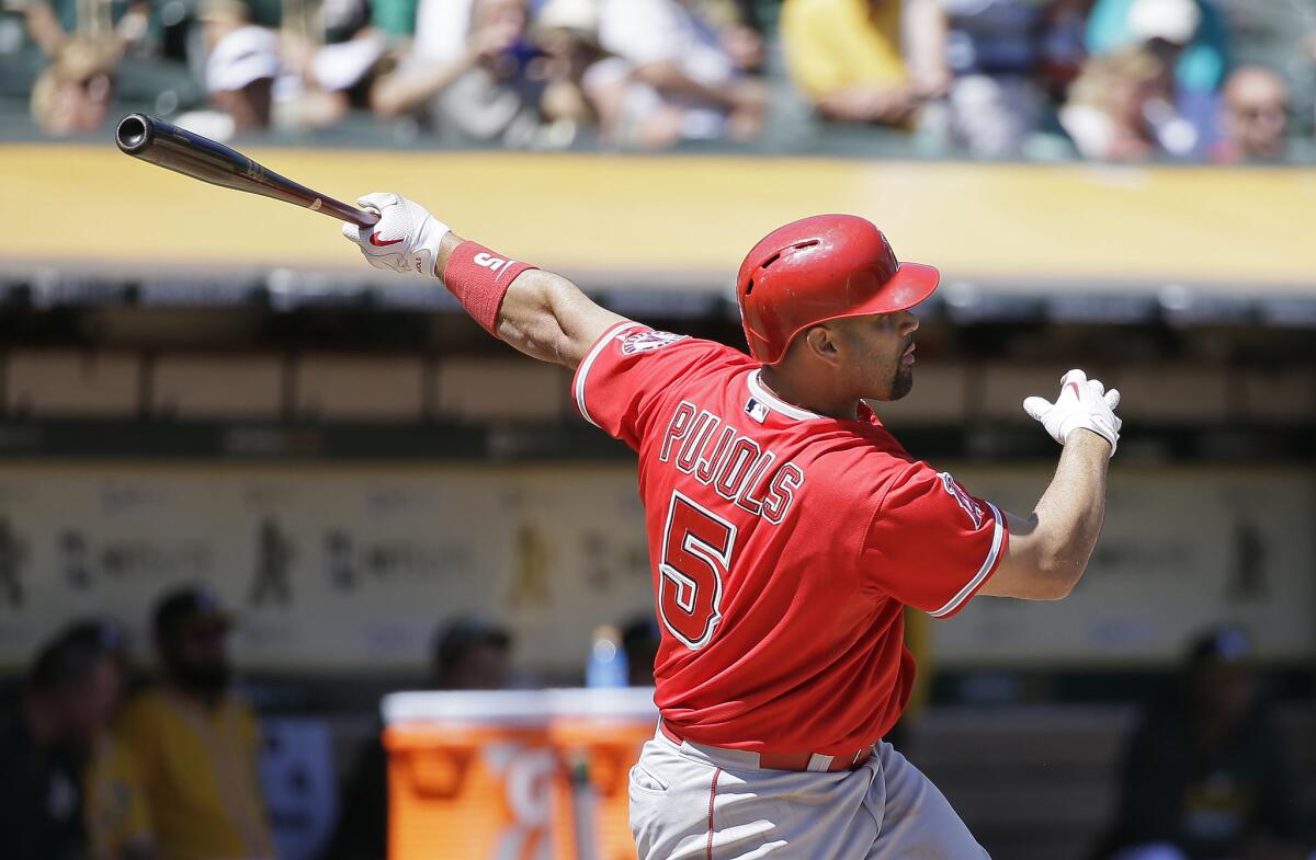 Angels slugger Albert Pujols hits a two-run home run off Athletics ace Sonny Gray in the second inning.