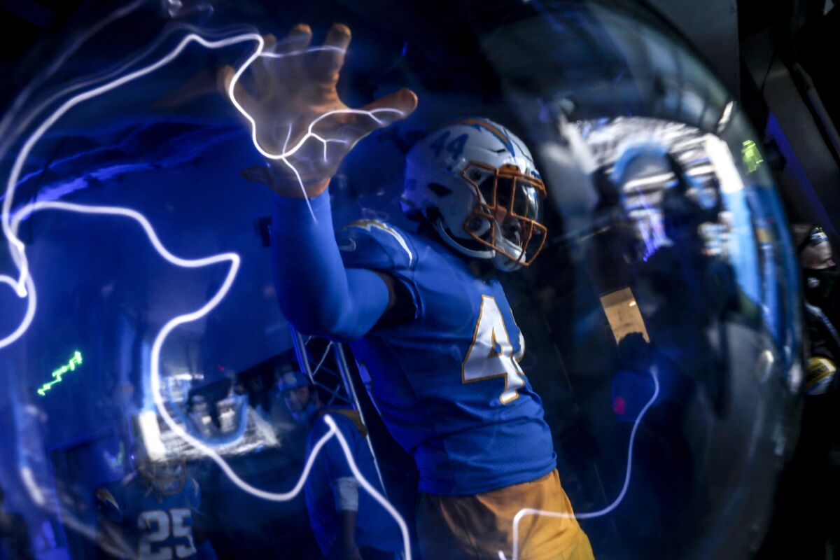 The Chargers' Kyzir White touches a lightning orb on his way into SoFi Stadium to play the Vikings in 2021.
