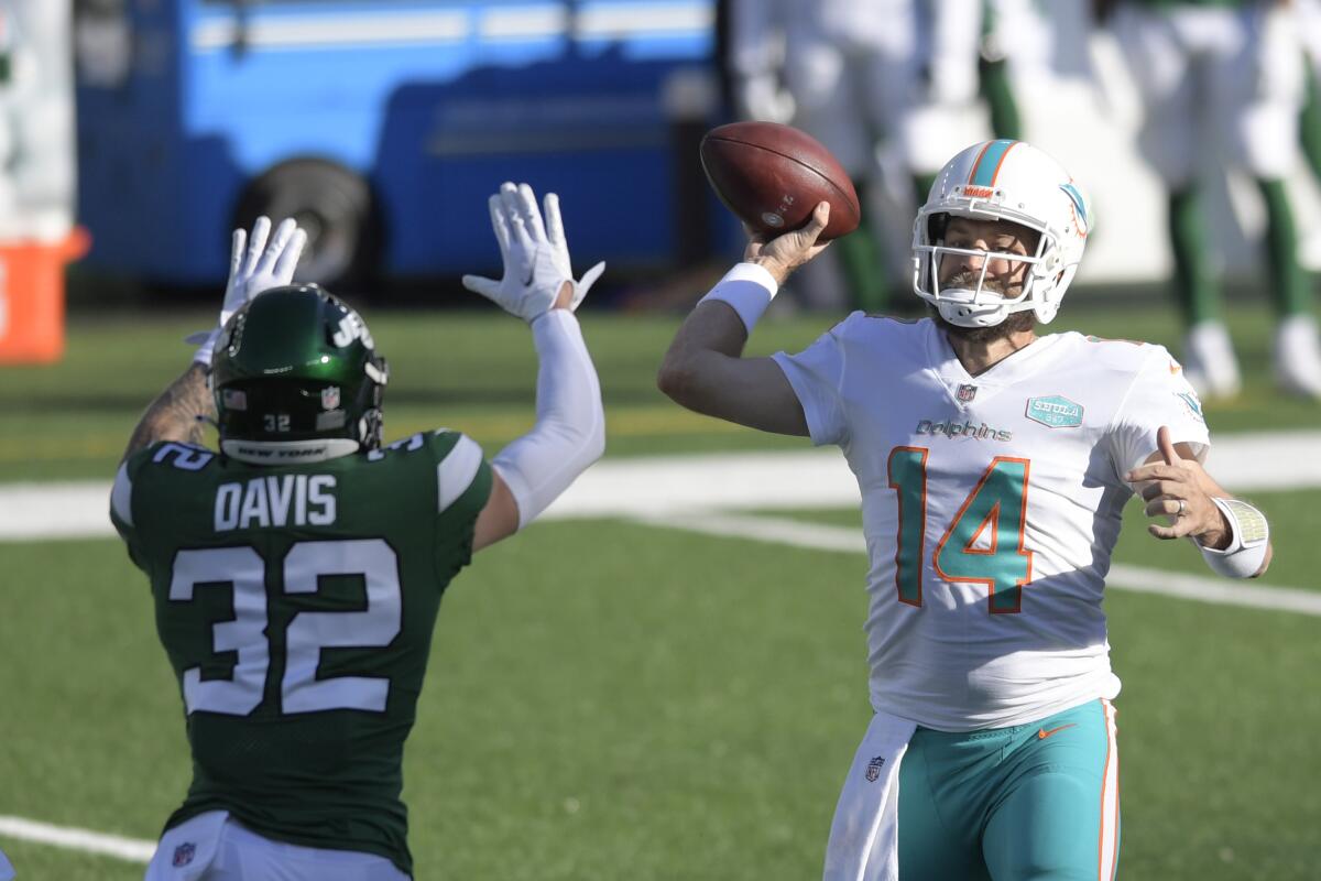 New York Jets safety Ashtyn Davis tries to block a pass from Miami Dolphins quarterback Ryan Fitzpatrick.