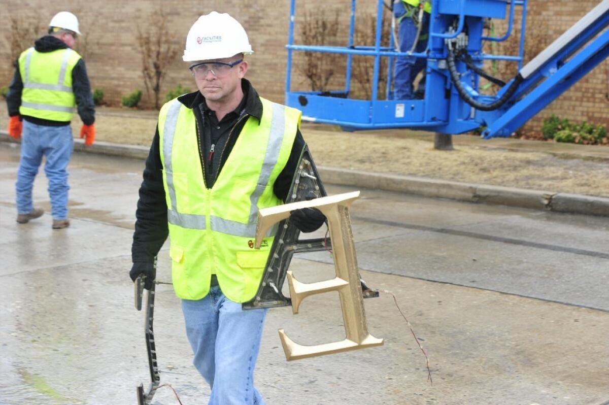 Maintenance worker Danny Feland with letters removed from the Sigma Alpha Epsilon house at the University of Oklahoma in Norman.