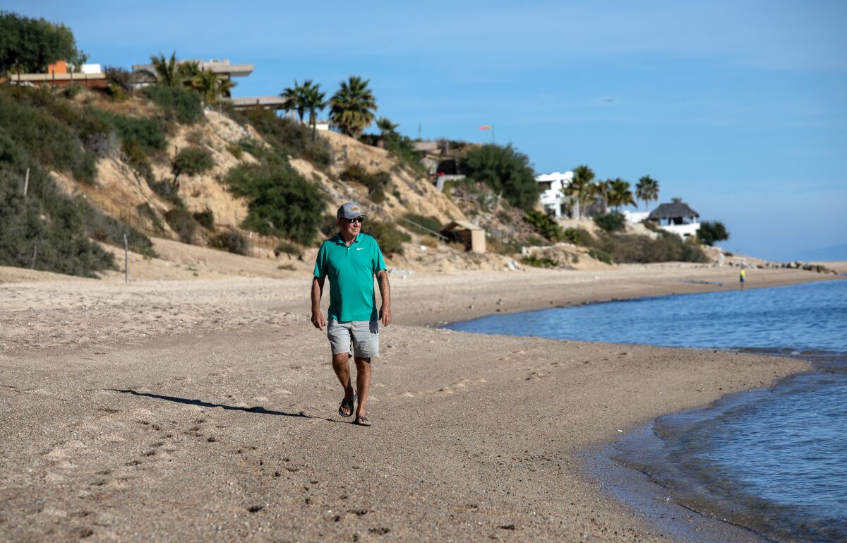A man walks on a beach