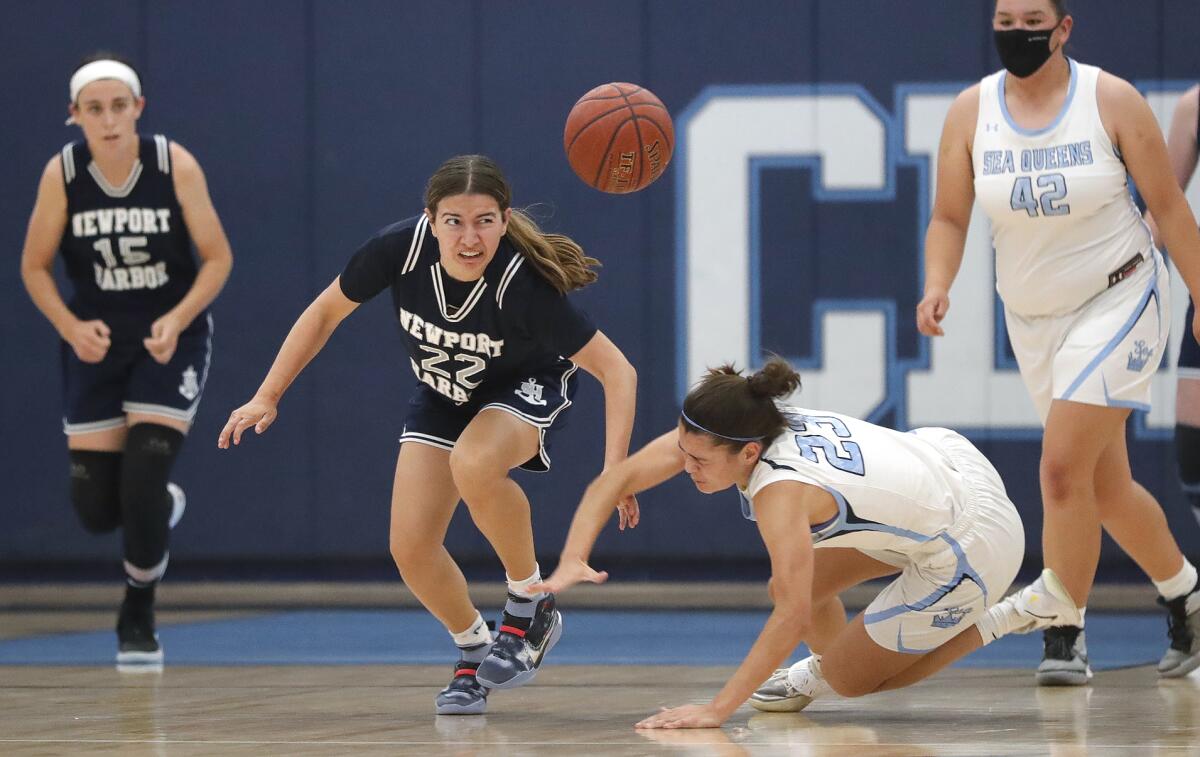 Newport Harbor's Chase Dionio (22) steals the ball during the Battle of the Bay girls' basketball game in April. 