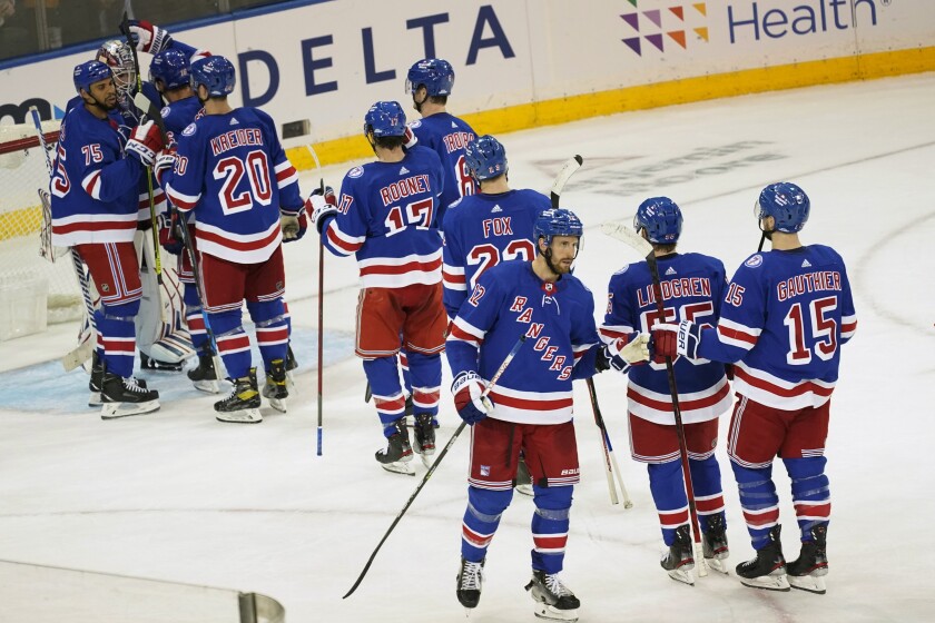 The New York Rangers celebrate after defeating the Philadelphia Flyers during their NHL hockey game, Wednesday, Dec. 1, 2021, at Madison Square Garden in New York. The Rangers won 4-1. (AP Photo/Mary Altaffer)