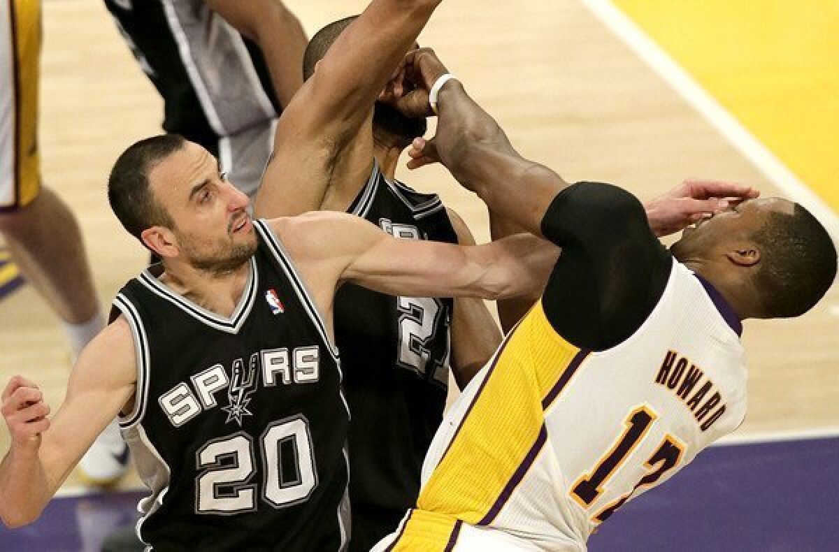 Lakers center Dwight Howard is fouled by Spurs guard Manu Ginobili while trying to score against Ginobili and power forward Tim Duncan in the second quarter of Game 4 on Sunday.