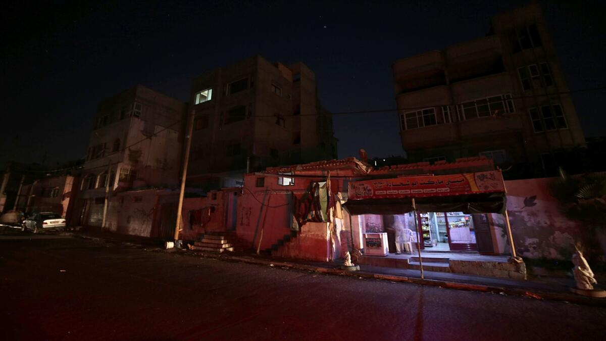 epa06118453 A small shop is seen between houses of Palestinian refugees during a power outage at al Shateaa refugee camp, in Gaza City, 30 July 2017. The 1.8 million people who reside in Gaza, experience some 20 electricity outages per day. According to reports on 16 April 2017, the Gaza Strip sole functioning power station ran out of fuel and stopped working. The Gaza power Generating Company plant usually operates only eight hours a day, after its fuel crosses into Gaza through the Israeli Kerem Shalom border crossing. EPA/MOHAMMED SABER ** Usable by LA, CT and MoD ONLY **