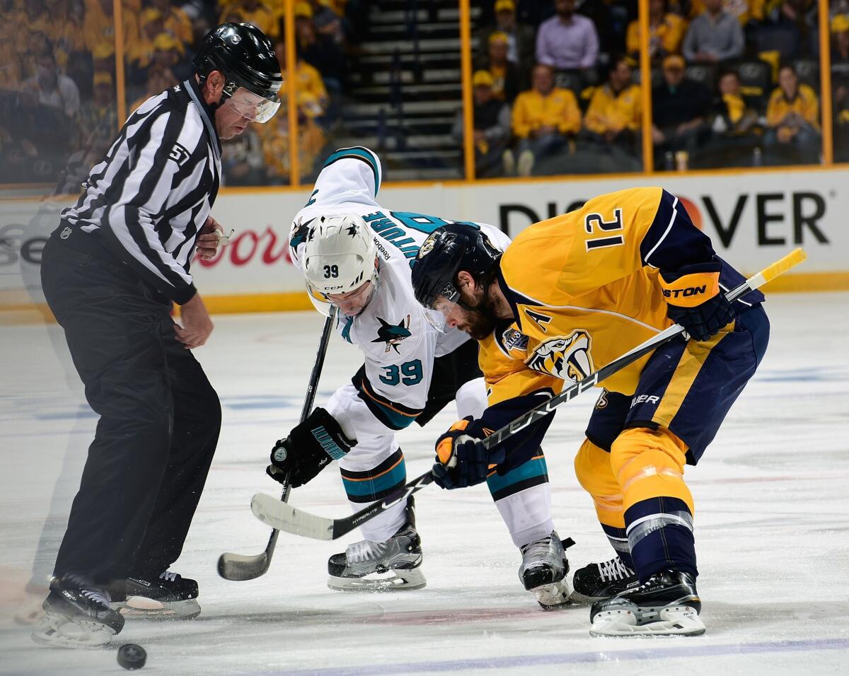 San Jose's Logan Couture (39) takes a faceoff against Nashville's Mike Fisher on May 9.