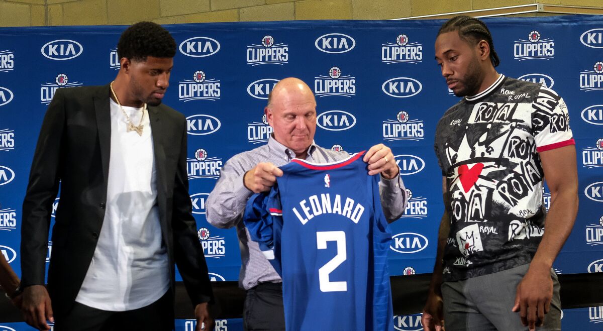Clippers chairman Steve Ballmer with Paul George, left, and Kawhi Leonard during a news conference Wednesday.