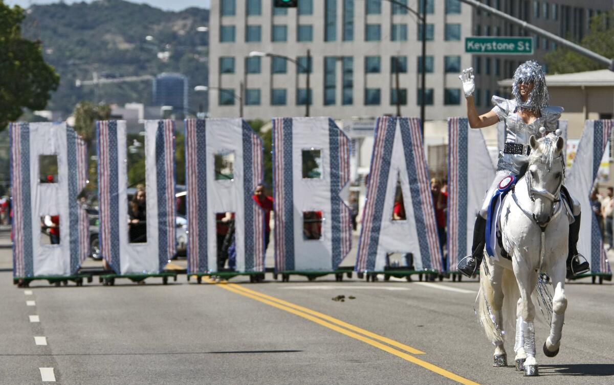 Romana Hartke of Burbank rides Pacifico at the start of the annual Burbank on Parade in Burbank on Saturday, April 26, 2014. The theme for this year's parade was City of the Future.