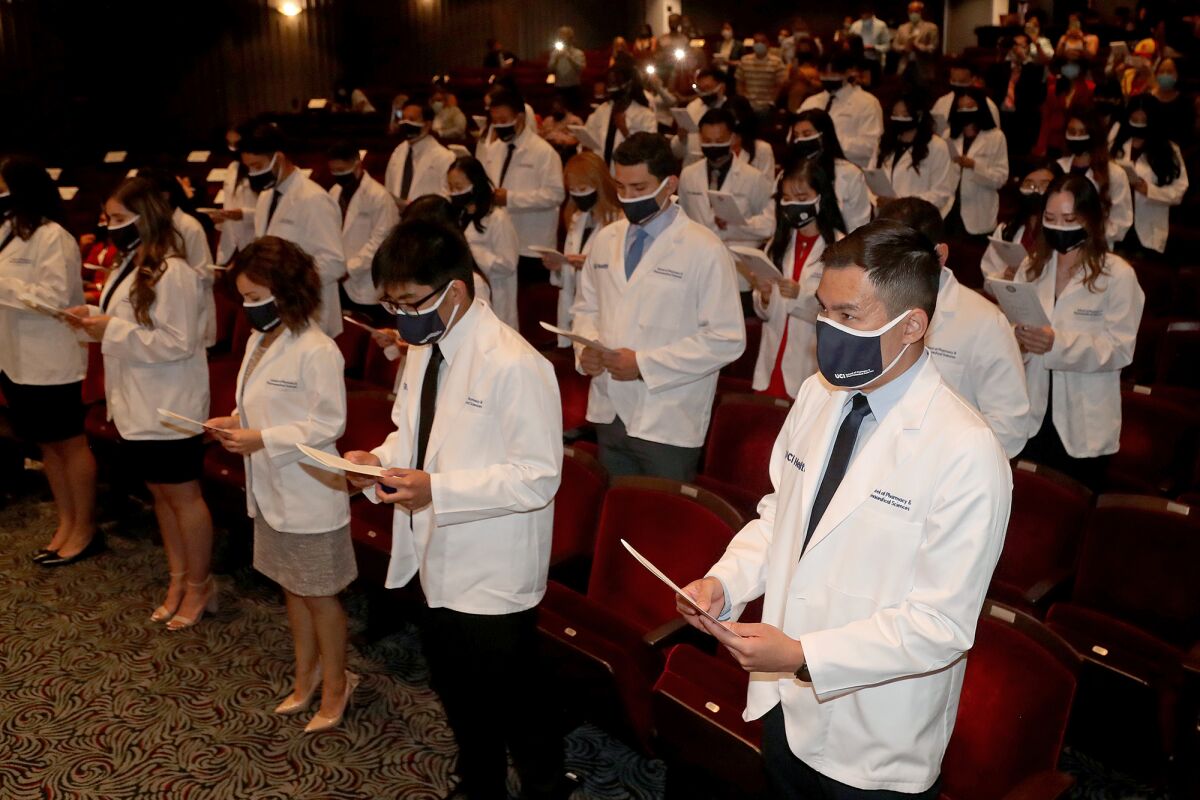 Students recite the Oath of a Pharmacist during the White Coat Ceremony at the Irvine Barclay Theater.