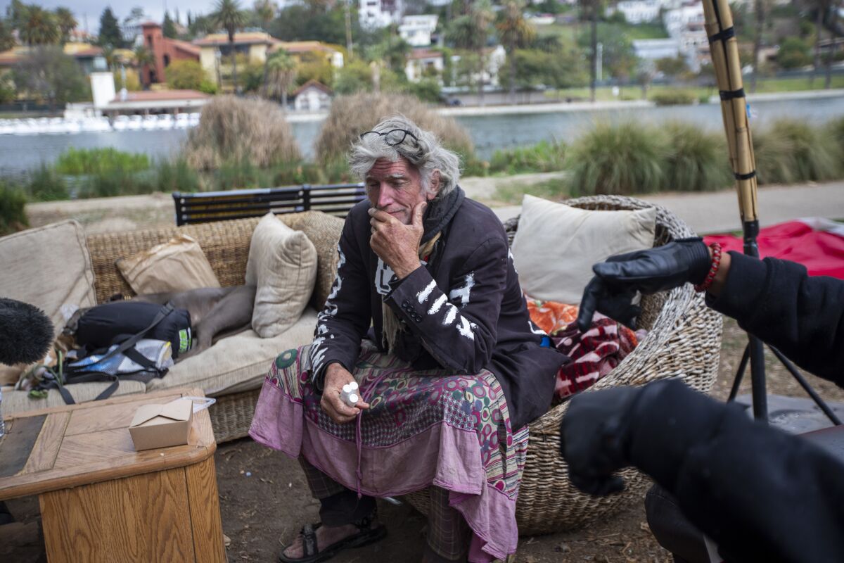 David Busch-Lilly sits on a sofa at Echo Park Lake in March 2021.