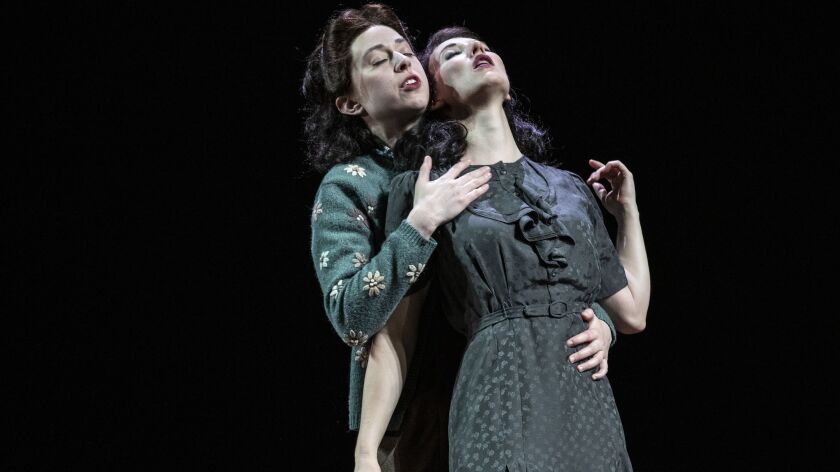 Elizabeth A. Davis, right, and Adina Verson embrace as lovers in "Indecent," a play by Paula Vogel at the Ahmanson Theatre.