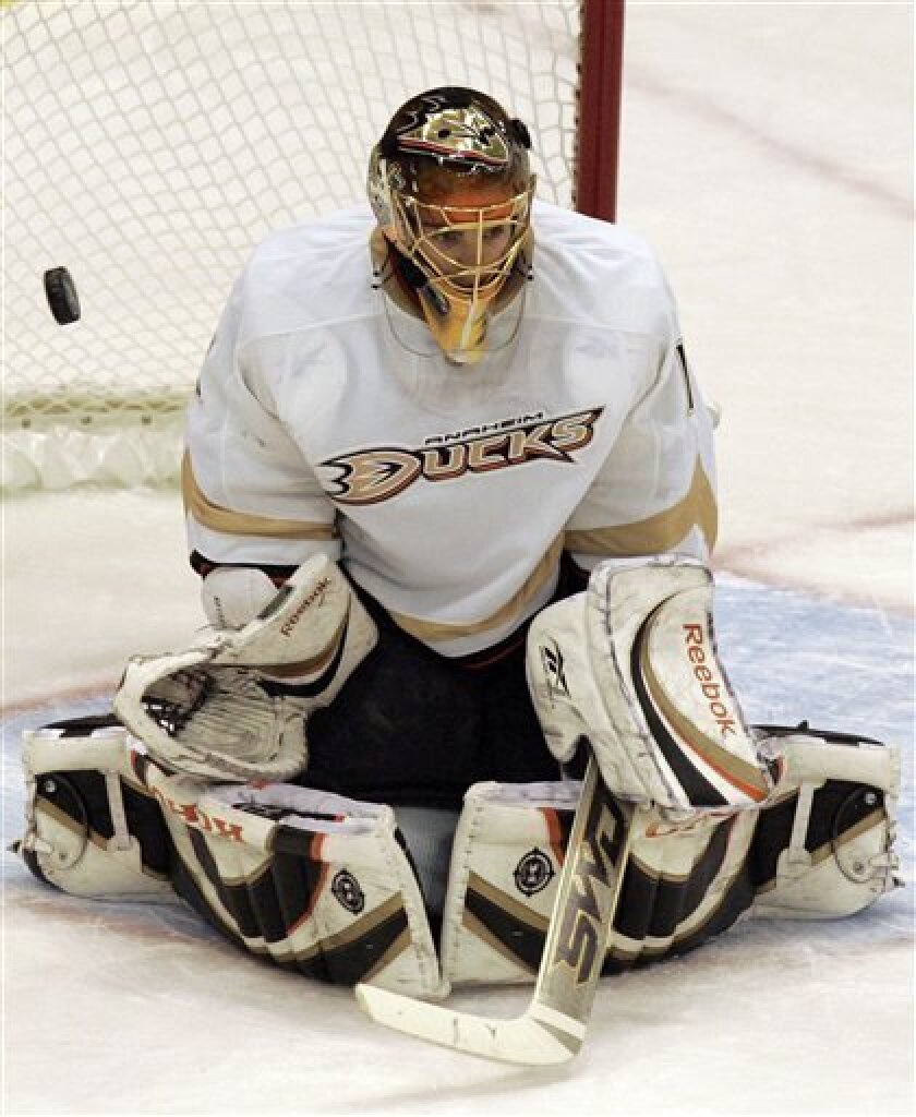 Anaheim Ducks goalie Jonas Hiller, of Switzerland, deflects a shot from the Detroit red Wings during the first period of Game 5 of a second-round NHL hockey playoff series, Sunday, May 10, 2009, in Detroit. (AP Photo/Carlos Osorio)