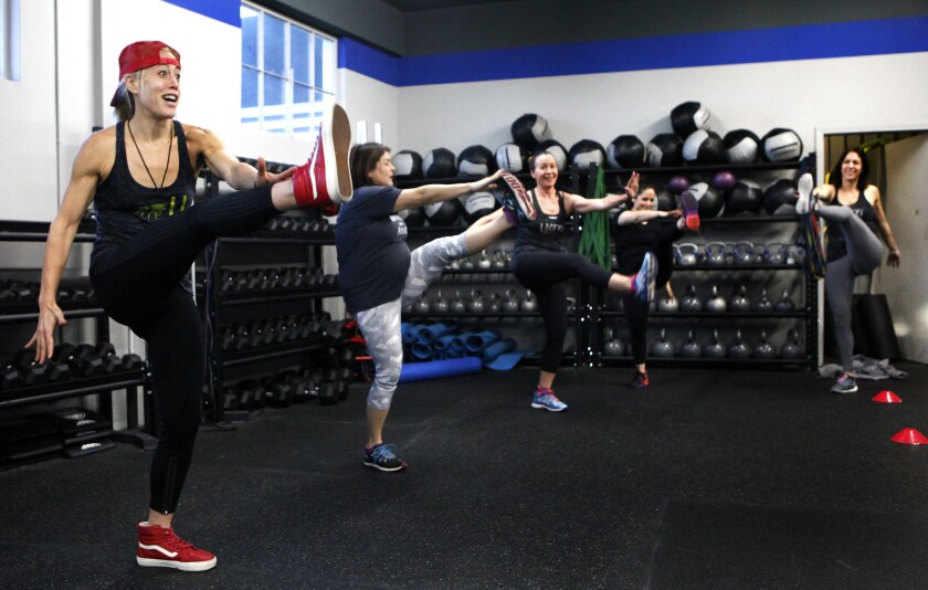Fitness trainer Lacey Stone, left, leads a boot camp class in Los Angeles in 2015. Researchers have found that high levels of exercise drive down the average risk for developing many kinds of cancers.