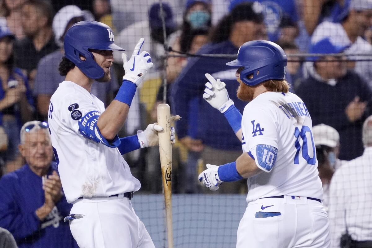 The Dodgers' Justin Turner, right, celebrates his home run with Cody Bellinger during the third inning.