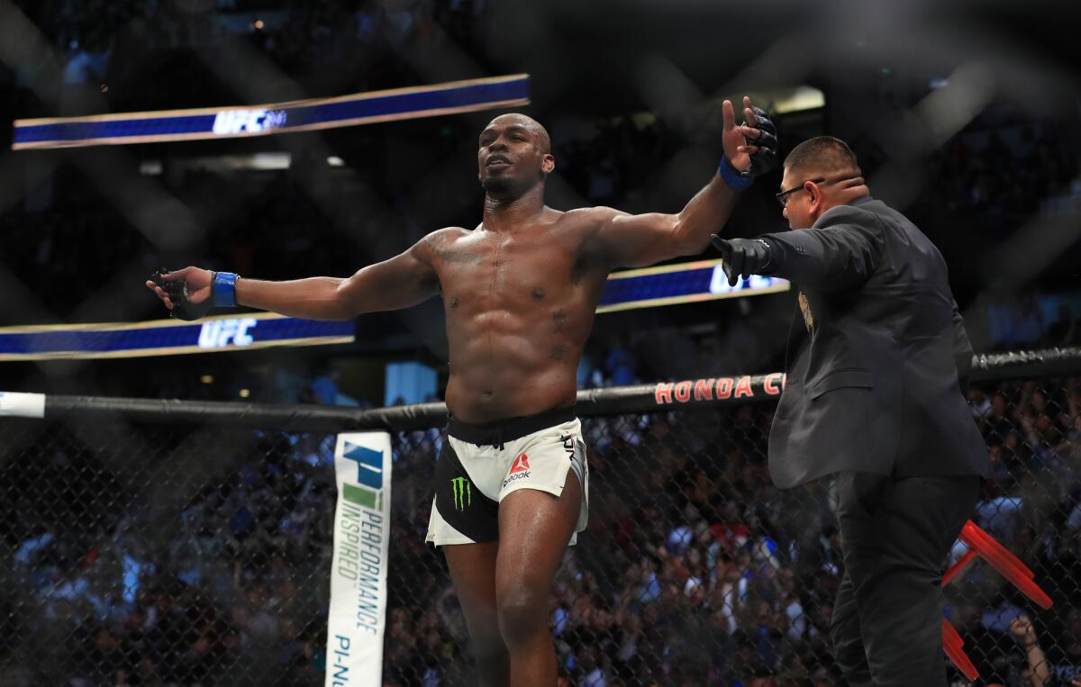 Jon Jones celebrates after stopping Daniel Cormier in the third round of their light-heavyweight fight at UFC 214 at Honda Center.