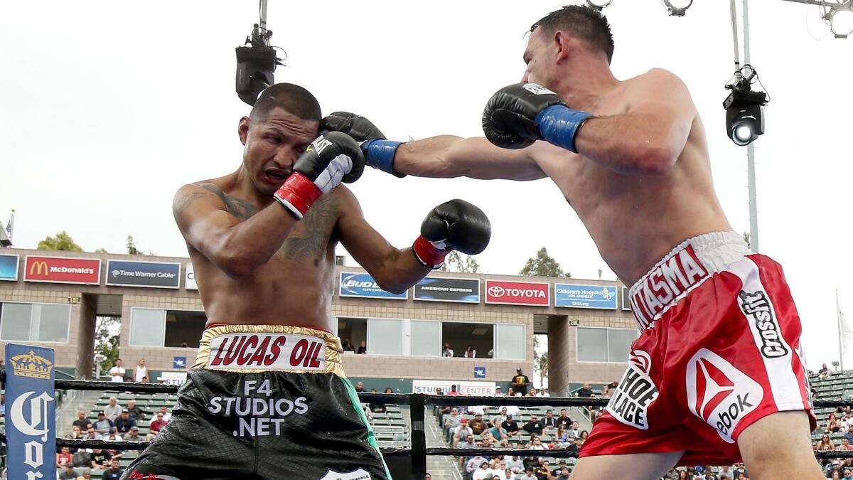 Robert Guerrero, right, throws a punch at Aron Martinez during their welterweight bout at StubHub Center in Carson on June 6, 2015. Guerrero won the 10-round bout in a split decision.
