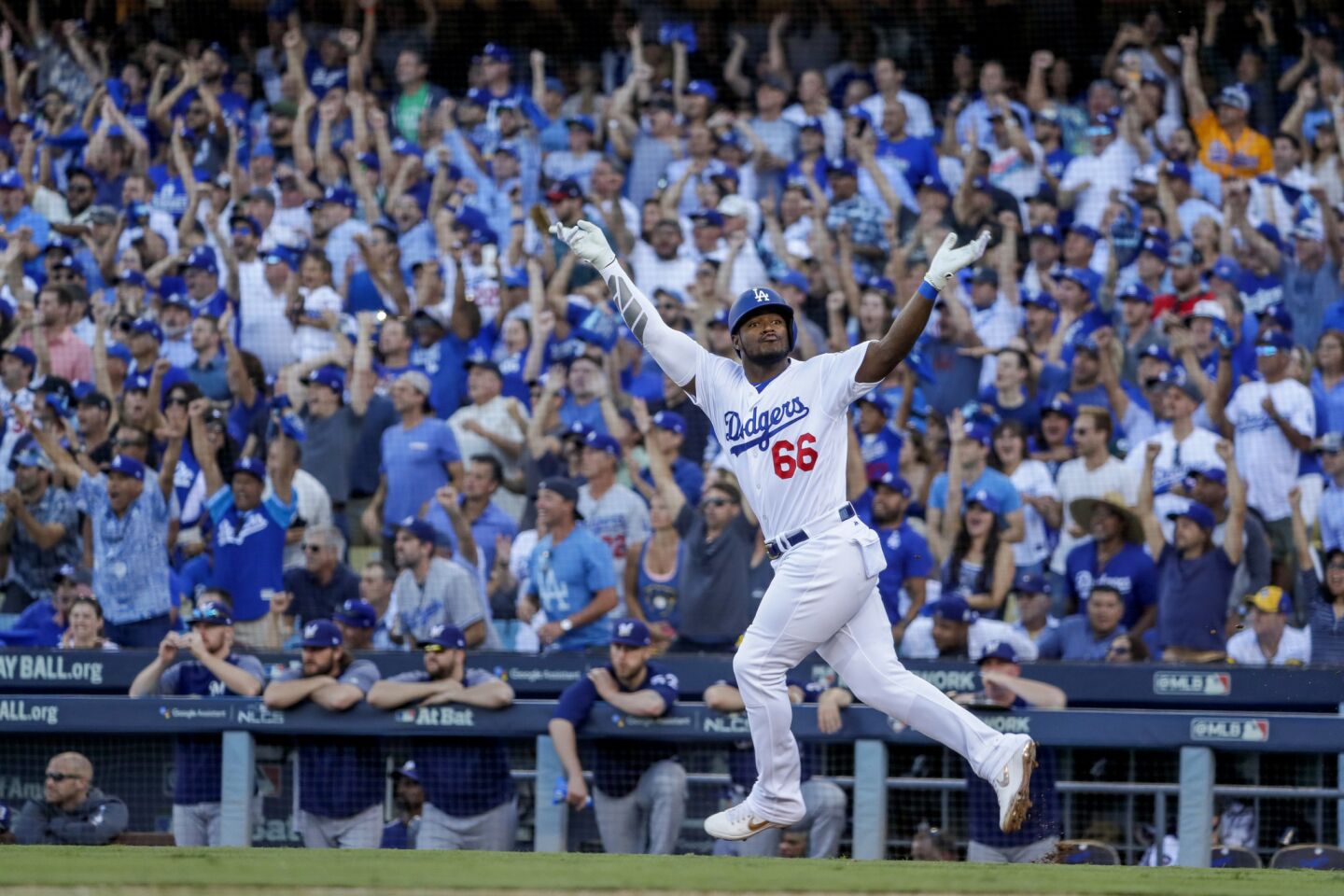 Dodgers Yasiel Puig celebrates while running out an RBI single in the sixth inning.