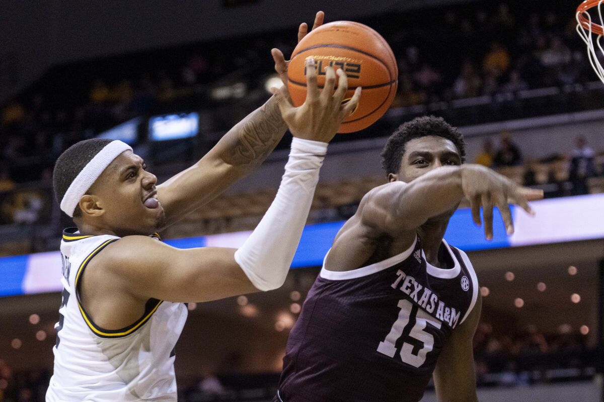 Missouri's Jarron Coleman, left, pulls down a rebound in front of Texas A&M's Henry Coleman III, right, during the second half of an NCAA college basketball game Saturday, Jan. 15, 2022, in Columbia, Mo. Texas A&M won 67-64. (AP Photo/L.G. Patterson)