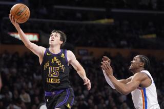 Los Angeles Lakers guard Austin Reaves, left, shoots as Oklahoma City Thunder forward Jalen Williams defends during the second half of an NBA basketball game Monday, Jan. 15, 2024, in Los Angeles. (AP Photo/Mark J. Terrill)