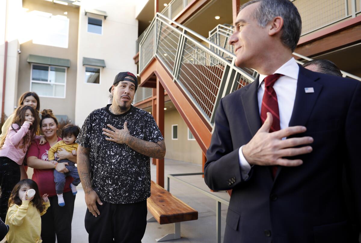 Mayor Eric Garcetti, right, shares a moment with the Ayala family