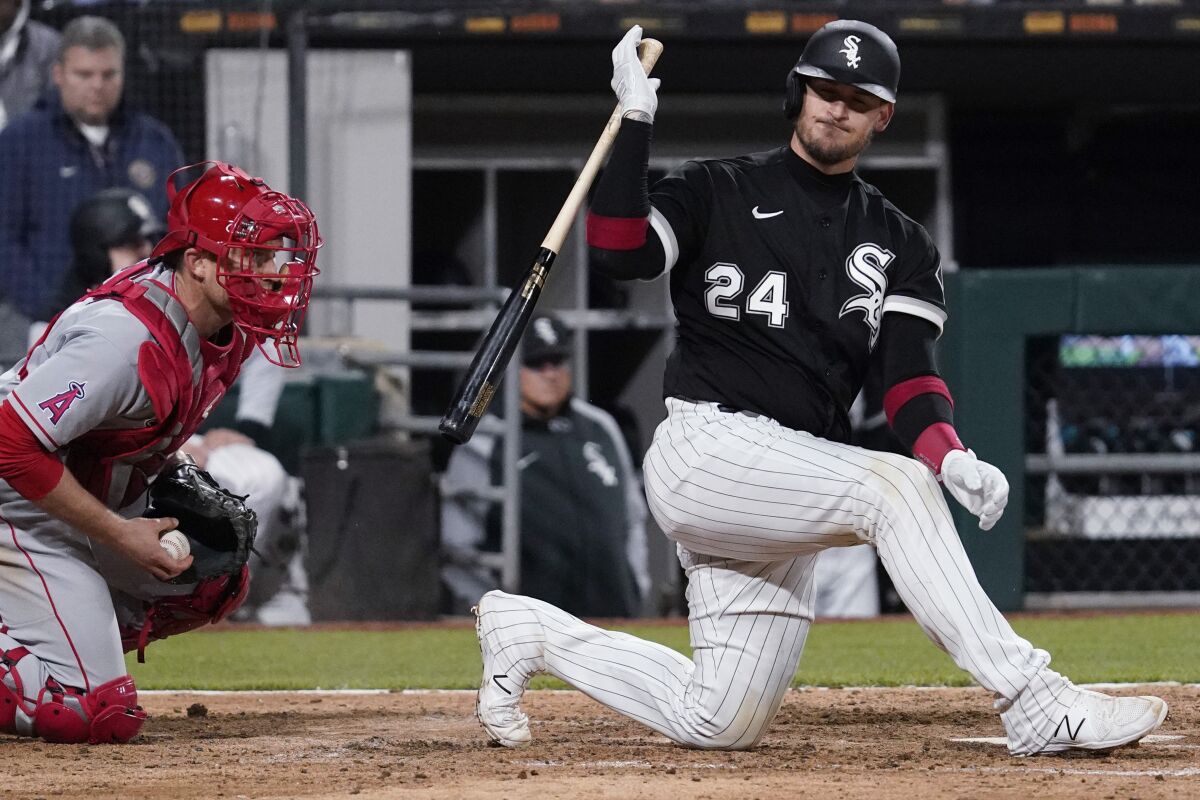 Chicago White Sox's Yasmani Grandal, right, reacts after striking out swinging during the ninth inning of a baseball game against the Los Angeles Angels in Chicago, Friday, April 29, 2022. (AP Photo/Nam Y. Huh)