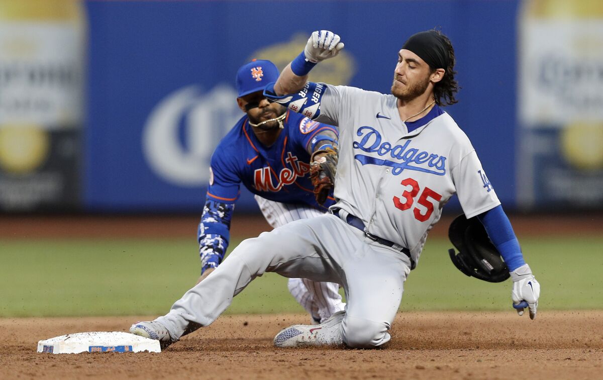 Cody Bellinger slides into second ahead of the tag of Jonathan Villar.