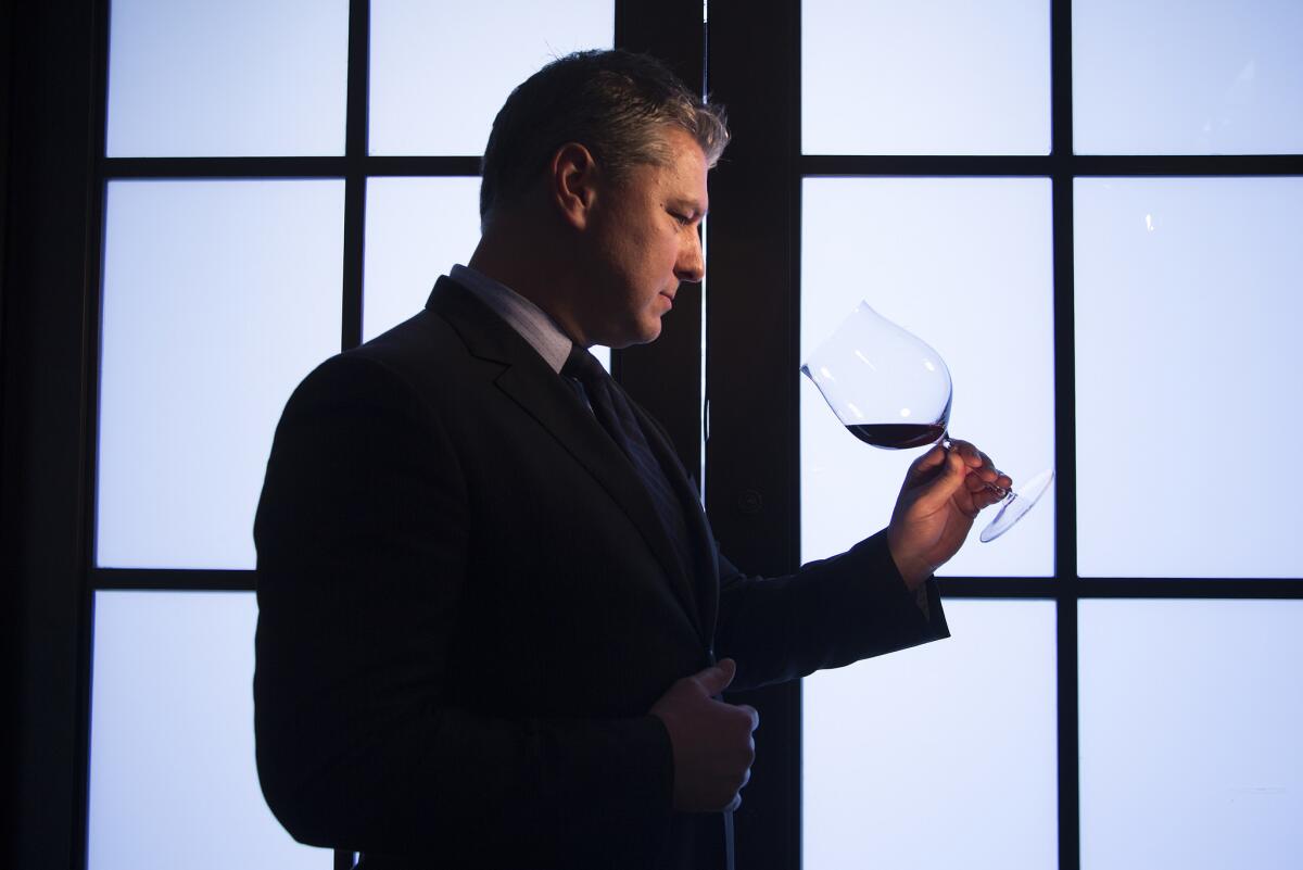 Wine Director Phillip Dunn tilts a glass of 2010 Gevrey Chambertin French burgundy at Spago.