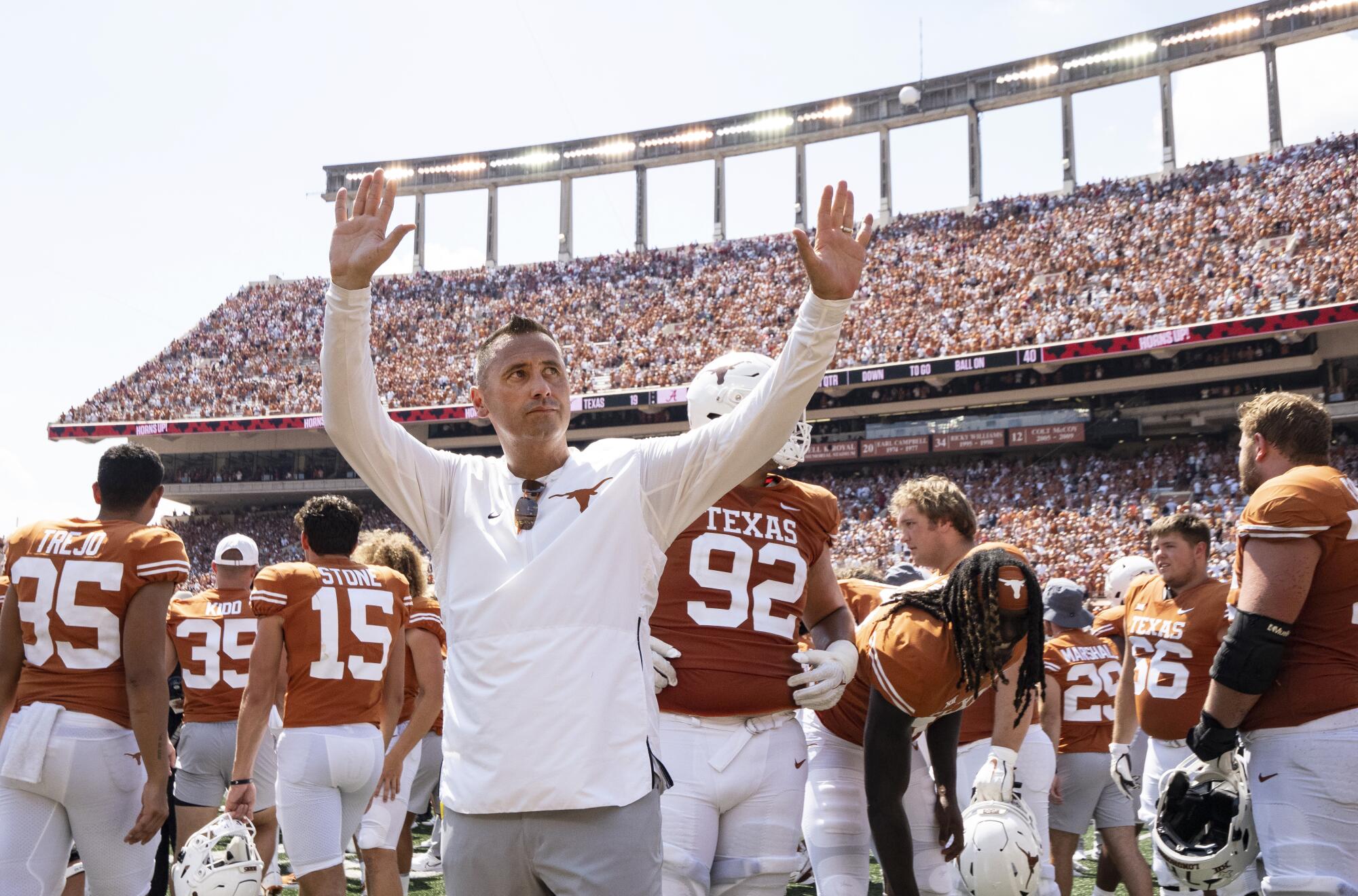 Texas coach Steve Sarkisian waves to the fans after the Longhorns' loss to Alabama.
