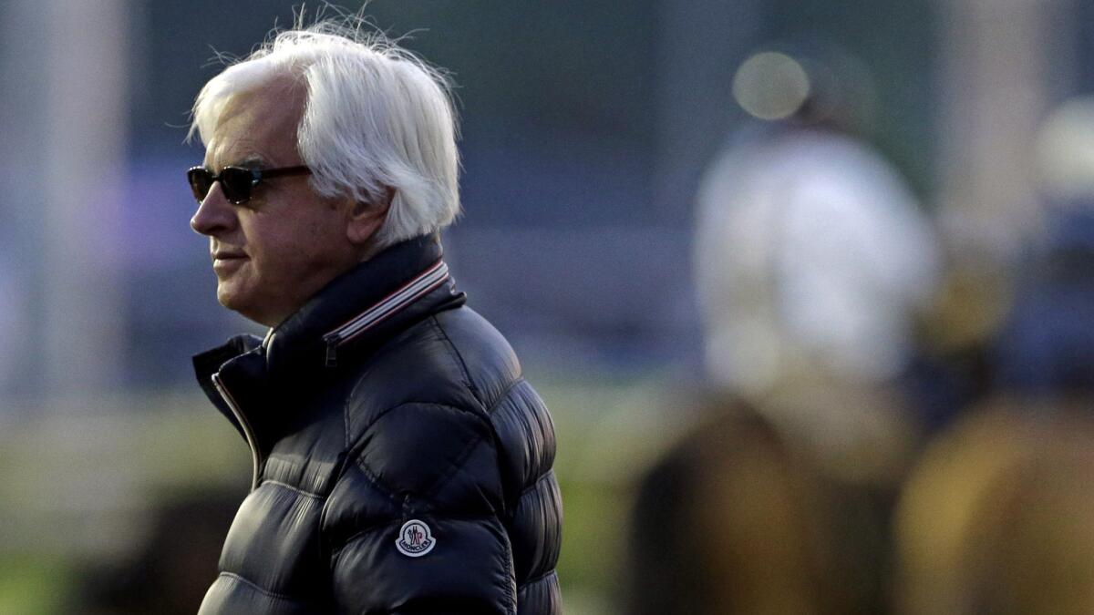 Bob Baffert watches morning workouts at Churchill Downs in Louisville, Ky., on May 1, 2014.
